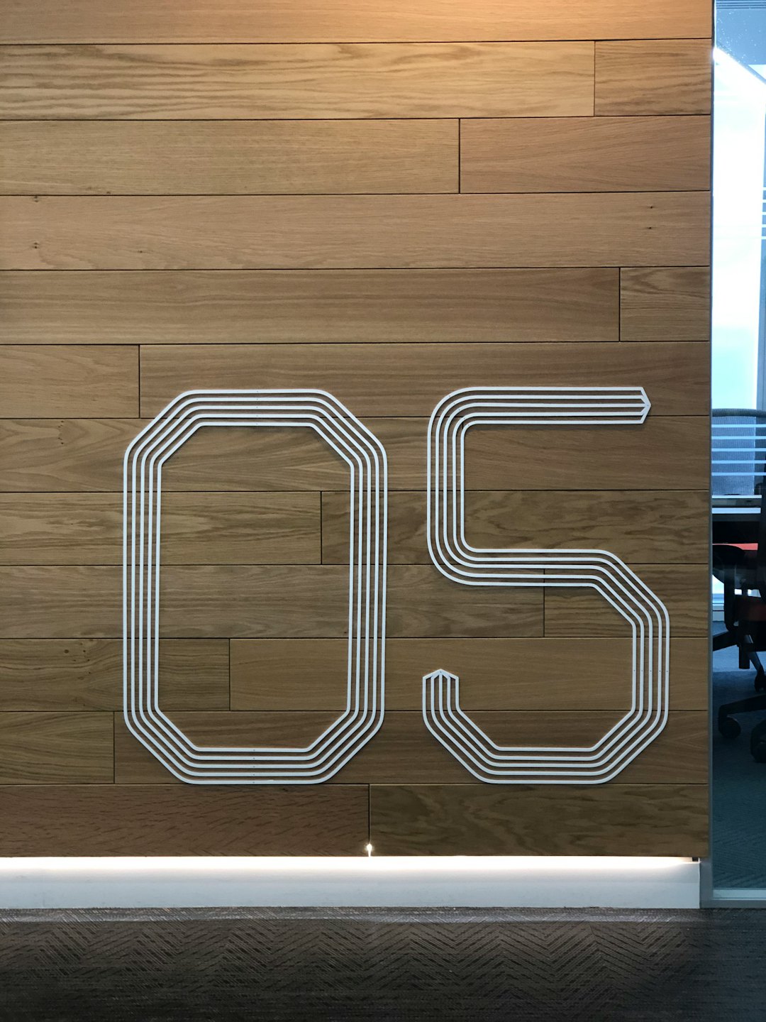Office wall with wood paneling and large number 05.