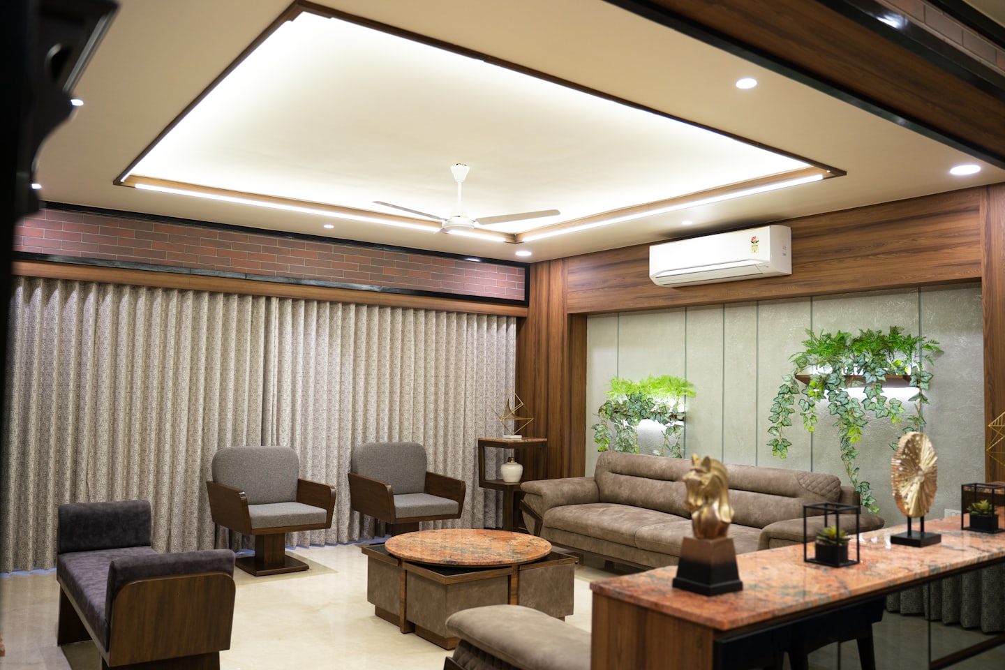 Modern living room with upholstered furniture and indoor wall planters.